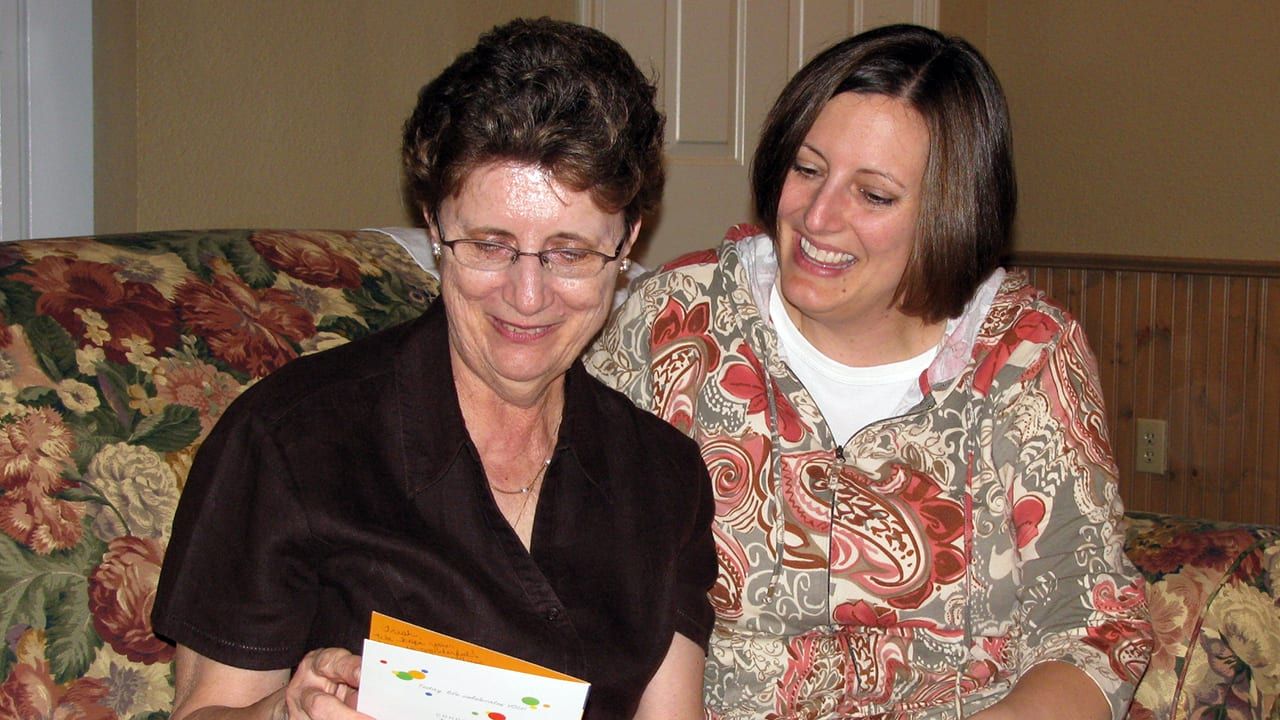 Sheryl and Trish looking at cards together on Trish’s 70th birthday