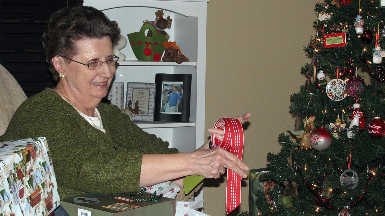 Trish opening a Christmas present